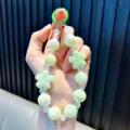 Cute luminous light green beaded phone chain with flower pendant - Green