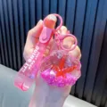 Rosa Muschel-Schlüsselanhänger mit Ölfüllung, Glitzer und Motiv-Handschlaufe - Rosarot Seestern Muschel