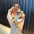 Camouflage fighter jet keychain with alloy pull-back model in hand-held display view - Yellow