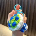 Handmade crochet flower bouquet keychain in blue and green with plastic clip - Blue