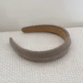 Close-up detail of a coffee brown textured sponge headband with a soft knit finish - Khaki Headband