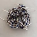 Detail view of a vintage plaid scrunchie decorated with delicate cream ribbon bows - White Blue Plaid Bow Scrunchie