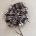 Detailed view of retro plaid scrunchie with thin brown ribbons on beige background - Gray Coffee Plaid Bow Scrunchie