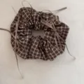 Close-up of vintage brown plaid scrunchie with decorative ribbons on grey background - Coffee Plaid Bow Scrunchie
