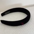 Detailed macro view of black velvet padded headband with a dainty burgundy bow detail. - Black Bowknot Headband