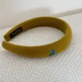 Detail view of mustard velvet sponge headband featuring a cute blue embroidered bow - Yellow Bow Headband