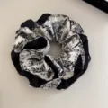 Close-up of French vintage toile de jouy print hair scrunchie in black and white - Scrunchie / Beige Floral