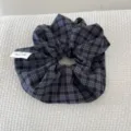 Macro view of a dark blue vintage plaid scrunchie with a handmade label tag - Navy Plaid Scrunchie