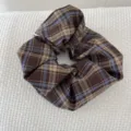 Detailed close-up of a retro brown and blue plaid scrunchie on textured white fabric - Coffee Tone Plaid Scrunchie