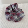 Detailed macro shot of a vintage red and blue plaid oversized fabric hair scrunchie - Mixed Plaid Scrunchie