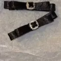Macro view showing the elegant black satin fabric and rhinestone buckle of the hair clips - Black Bow / Black