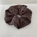 Detailed view of a retro brown plaid scrunchie hair tie showing fabric texture - Purple Gingham