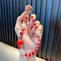 Cute red faceted crystal beaded keychain with clear flower charms and large red bead - Red