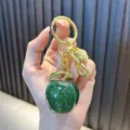 Sparkling green apple resin keychain with gold-toned hardware and glitter - Apple / Green