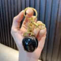 Charming black glittery resin apple keychain pendant with a golden rabbit charm - Small Apple / Black