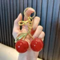 Exquisite red resin cherry keychain with gold metal clasp and sparkling glitter detail - Cherry (Fine Glitter) / Red