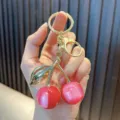 Cute pink resin cherry keychain with gold-plated ring and lobster clasp hanger - Phantom Cherry / Rose Red