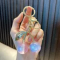 Cute cherry keychain with iridescent pink and purple resin globes and gold hardware - Phantom Cherry / Pale Blue