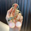 Exquisite cute pink resin cherry keychain with golden leaf charms and a lobster clasp - Iridescent Cherry Pink White