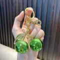 Shiny green resin cherry keychain featuring a gold-plated hardware ring and clasp - Cherry / Iridescent Bright Green