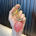 Glittery pink resin fruit charm keychain with gold clip for car keys or bag decor. - Glitter Strawberry / Transparent Pink