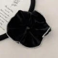 Close-up detail of a black velvet scrunchie featuring elegant sparkling rhinestone edges - Black Velvet Rhinestone - Hair Tie