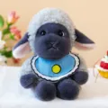 Adorable black-faced plush sheep toy wearing a blue bib, featuring soft curly grey fur. - Plush Toy / Gray Sheep Black Face / 23cm