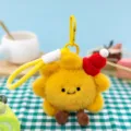 Macro view of cute yellow plush sunflower keychain featuring a red knitted Santa hat - Little Sun