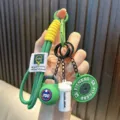 Mini fitness keychain featuring green kettlebell weight plate and shaker bottle charms - Green