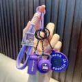 Purple fitness-themed keychain with mini kettlebell, barbell, and shaker bottle charms - Purple