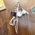 White baseball themed keychain featuring braided rope, bat and glove charms for bags - White