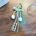 Handmade colorful woven bag charm with green heart carabiner, tulip buds and tassel - Green