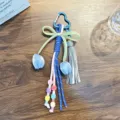 Handmade woven heart-shaped bag charm keychain with tassel and blue tulip details - Blue
