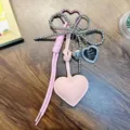 Pink PU leather heart keychain with beaded bow and small heart-shaped photo frame charm. - Pink