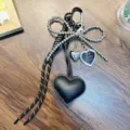 Elegant black PU leather heart keychain featuring a silver bead bow and heart charms ornament - Black