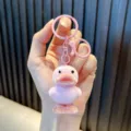 Pink flocked duckling keychain with matching plastic rings and lobster clasp. - Pink