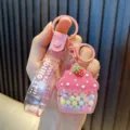 Cute pink cupcake keychain charm featuring colorful sugar beans and glittery strap accent - Pink