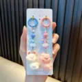 Cute pig and rabbit phone charms featuring blue and pink rings for backpack decor - Stick