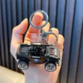 Cool black police car model keychain with pull-back function and mounted gun - Machine Gun