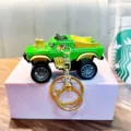 Creative green monster truck keychain with gold accents displayed on a purple display block - Green (Random Gold/Silver Base)