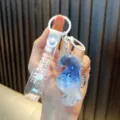 Cute blue liquid-filled seahorse keychain with glitter and JUST KEEP DOING IT strap - White