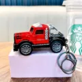 Red pull-back truck model keychain with silver roll bar and flame decal - Red