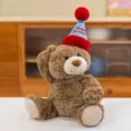 Adorable brown plush teddy bear wearing a festive blue Happy Birthday party hat - Height Approx 28cm / Brown (Birthday Hat Style)