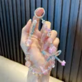 Correa para teléfono de cuentas coloridas con flores rosas y lazos azules para niñas - Rosa
