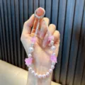 Handmade beaded flower phone strap keychain featuring pink pearls and floral charms - Purple
