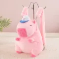 Soft pink plush capybara backpack featuring a cute blue cap and thick furry straps - Pink Capybara Hat Style