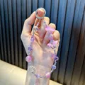 Purple beaded phone charm with 3D flower pendants, cute crystal bag strap accessory. - Purple