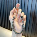 Handmade beaded phone strap with grey pearls, crystal beads, and flower charms - Black