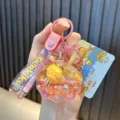 Pink shell acrylic keychain featuring a cute yellow duck with floating glitter and liquid - Pink