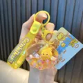 Yellow shell-shaped liquid glitter acrylic keychain with cute Genki Duck character and strap - Yellow